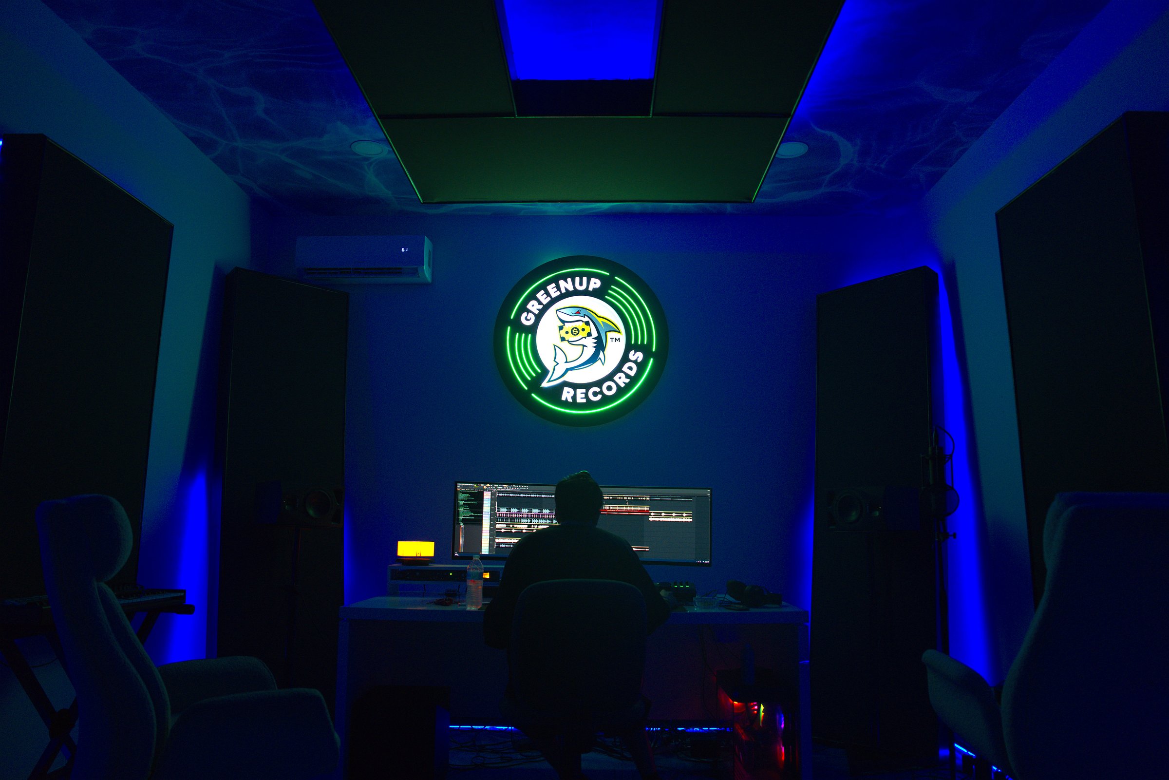 Greenup Records studio — ocean-themed ceiling with neon logo, session in progress